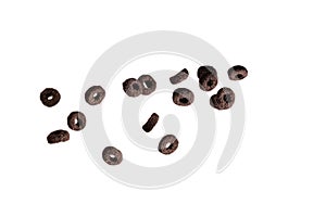 Chocolate rings cereal spill out into a bowl. Breakfast