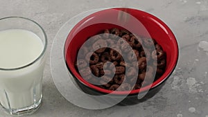 Chocolate rings cornflakes falling in bowl