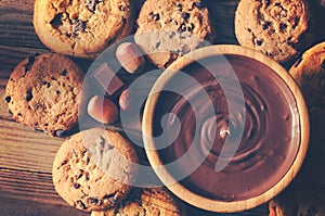 Chocolate sauce and cookies on wooden table - Top view