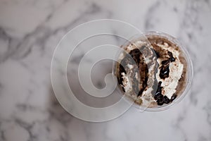 Chocolate sauce and whipped cream on top iced drink