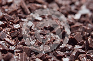 Chocolate shavings close-up, brown background