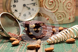 Chocolate, sifter, almonds and clock