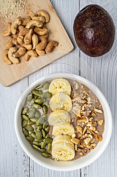 Chocolate smoothie bowl Chocolate , avocado , banana , almond milk topped with sliced banana, Pumpkin seeds, chopped  nuts and