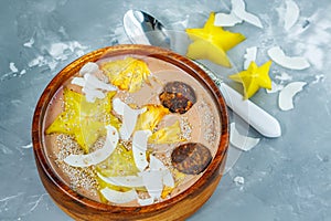 Chocolate smoothie bowl with exotic fruits and energy balls.