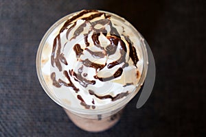 Chocolate frappe and whipping cream topping in cafe. photo