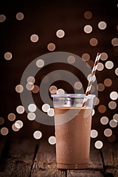 Chocolate smoothie or milkshake with party lights photo