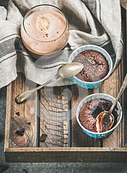 Chocolate souffle in baking cups and mocha coffee in glass