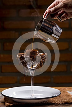 Chocolate Souffle being poured into a glass with petit gateau