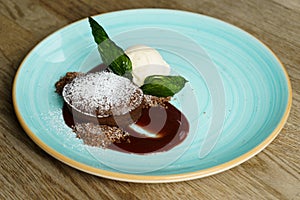 Chocolate souffle with strawberry sauce and vanilla ice cream