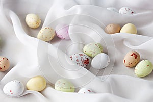 Chocolate specled Easter eggs in gauze fabric folds
