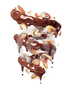 Chocolate splashes in spiral shape with with various nuts, isolated on a white background