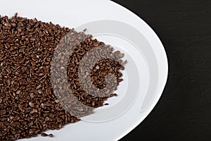 Chocolate sprinkles background. View of granulated chocolate photo