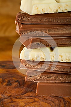 Chocolate stack of dark and white chocolate with brown background