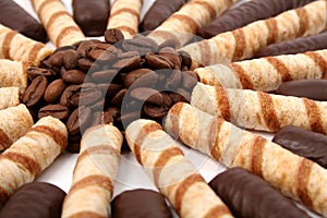 Chocolate sticks with a cream and the grains of coffee