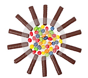 Chocolate sticks with a cream and the multi-coloured sweets isol