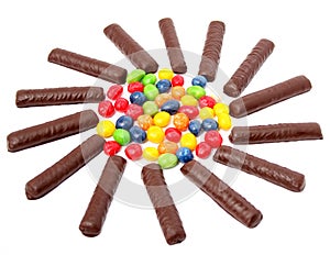 Chocolate sticks with a cream and the multi-coloured sweets isol