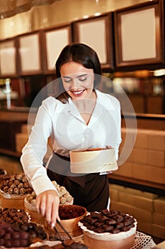 Chocolate Store. Woman Working In Chocolate Shop