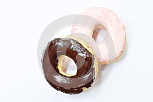 Chocolate and strawberry cream donuts on white background