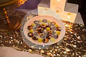 Chocolate sweets with nuts laid out on a plate