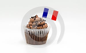 Chocolate swirl cupcake with a tricolor French flag toothpick in it isolated on white
