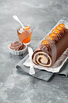 Chocolate swiss roll cake with candied kumquats