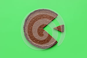 Chocolate tart top view on a green background. Pie chart concept