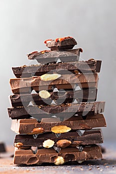 Chocolate tower. Ð¡hocolate bars with nuts, berries and coffee beans