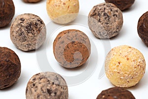 Chocolate truffle candies on a white background, close-up