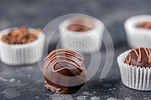 Chocolate truffle, coffee beans on a dark background. Homemade candy. Macro.