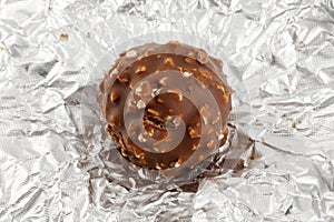 Chocolate truffle on silver wrapper