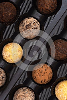 Chocolate truffles in a box, top view. Confectionery