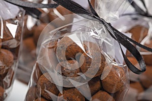 Chocolate truffles in luxury bags with focus on foreground