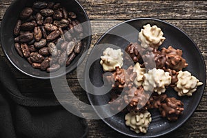 Chocolate truffles. Sweer pralines on plate on wooden table