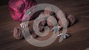Chocolate truffles on textured wooden background