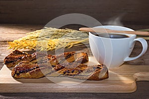 Chocolate twist bread and coffee on table