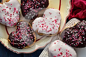 Chocolate and vanilla heart donut with tiny red heart sprinkles on top