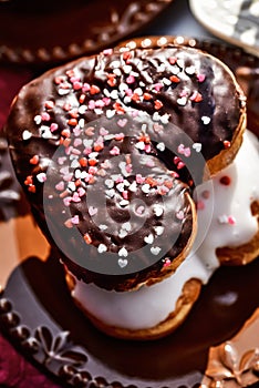 Chocolate and vanilla heart shaped donuts stacked