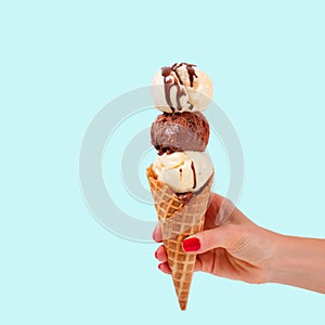 Chocolate and vanilla ice cream cone on faded pastel color background