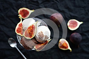 Chocolate and vanilla ice cream scoops with fig pieces