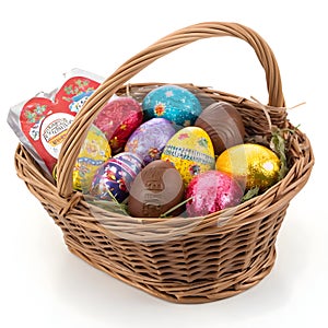 Chocolate and vitamin Easter eggs basket isolated on white photo