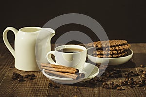 Chocolate wafers, creamer and cup of coffee with cinnamon sticks/chocolate wafers, creamer and cup of coffee with cinnamon sticks