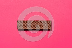 Chocolate wafers on pink  background