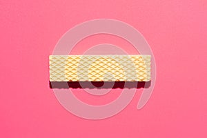 Chocolate wafers on pink  background