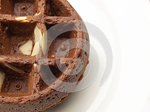 chocolate waffle with almond slide on a white plate, fresh baked for sweet meal, dessert concept