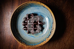 Chocolate waffle in handmade clay plate