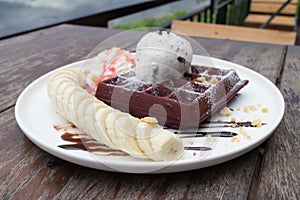 chocolate waffles with vanilla ice cream, banana, whipped cream