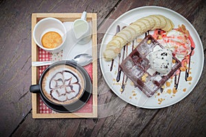 Chocolate waffles with vanilla ice cream, banana, whipped cream