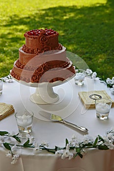 Chocolate wedding cake on table