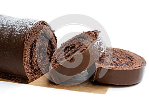 Chocolate yule log christmas cake coated with milk chocolate isolated on white