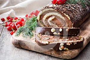 Chocolate yule log christmas cake with red currant